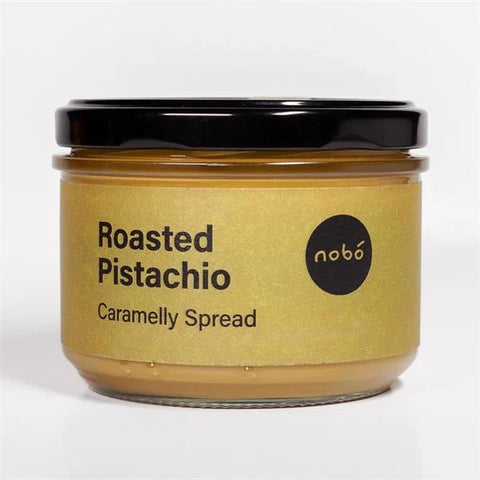 Jar of roasted pistachio caramelly spread with 'nobö' branding on a white background