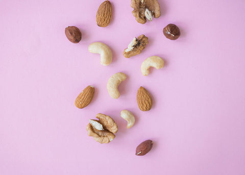 Various nuts on as pink background